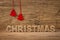 The word christmas in front of a wooden background