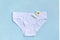 Word CLEAN from white thread hygienic female tampon, chamomile flower and women`s panties on blue background. Concept hygiene