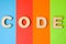 Word code is composed of 3D letters is in background of 4 colors: blue, red, orange and green. Illustration of code language for p