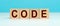Word CODE made with cube wooden block