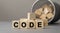 Word CODE made with cube wooden block on a desk