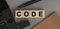 Word CODE made with wood building blocks. Top view