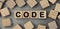 Word CODE made with wood building blocks. Top view