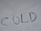 The word `cold` written in snow