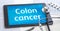 The word Colon cancer on the display of a tablet