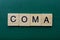 Word coma made from gray wooden letters