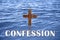 Word Confession near wooden Christian cross in water