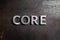 The word core laid with silver metal letters on rusted burnt iron flat surface background