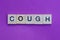 Word cough from wooden letters