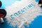 Word creatine written on a white scattered powder  on a blue background - concept of wellness