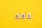 Word CSS made from wooden letters on yellow background. Cascading Style Sheets