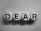 Word dear spelled on dice