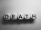 Word death spelled on wooden dice