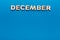 Word December on blue background