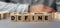 The word DEFINE made from wooden cubes. Selective focus