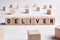 The word deliver on wooden cubes. Delivery, distribution or logistic service concept