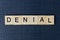 Word denial from gray wooden letters