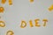 word DIET consists of edible letters. Pasta Diet Food. Pasta in form of letters on gray background. Proper nutrition concept