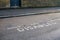 Word DISABLED written on asphalt near reserved parking space at street in outer London