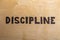 The word discipline burnt on white flat wooden surface - directly above normal view