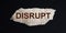 word DISRUPT on a piece of brown paper
