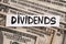 The word Dividends on dollar bills