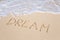 Word DREAM on beach - vacation concept background