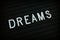 The word Dreams on a Letter Board