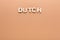 Word Dutch on beige background