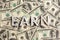 The word earn laid with aluminium letters on the US dollar banknotes background - with selective focus