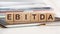 the word ebitda is written on wooden cubes, concept