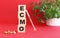 The word ECMO is made of wooden cubes on a red background. Medical concept