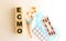 The word ECMO is made of wooden cubes on a white background. Medical concept