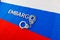 the word embargo laid with silver metal letters on russian tricolor flag with silver handcuffs
