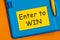 The word Enter to win is written in marker on the yellow paper for notes