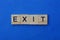 Word exit made from brown wooden letters