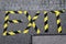 The word exit written with yellow and black barrier tape onto a sidewalk