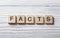 Word FACTS on wood abc cubes at wooden background. Education concept.