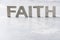 Word FAITH made with cement letters on grey marble background. Copy space. Biblical, spiritual or christian reminder