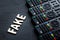 The word fake on a dark background opposite a row of TV remotes