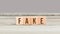 Word Fake on wood cubes