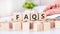 Word Faqs on the wooden blocks on table, business concept