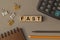 Word - FAST - on small wooden blocks on the desk. Top view