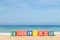 Word FEELGOOD in colorful alphabet blocks on tropical beach