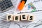 The word fees on wooden cubes with office desktop. Business financial costs and fees calculation or analysis