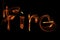 Word fire wave motion glowing lines on dark background