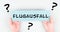 The word flight cancellation is standing in german language on the paper, staff shortage at the airport, vacation delayed