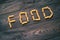 Word FOOD written pasta on the wooden table