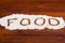 The word food written in stevia powder on wooden background