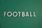 Word football arranged on green background